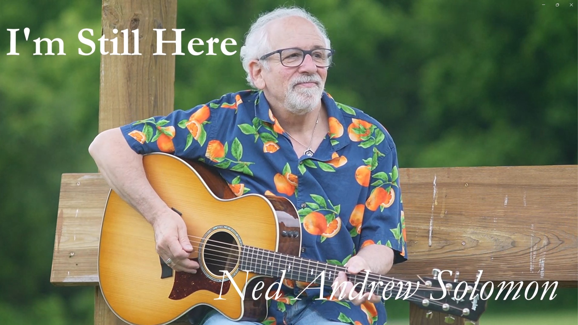 I'm Still Here Thumbnail with Ned Andrew holding his Taylor Acoustic Guitar