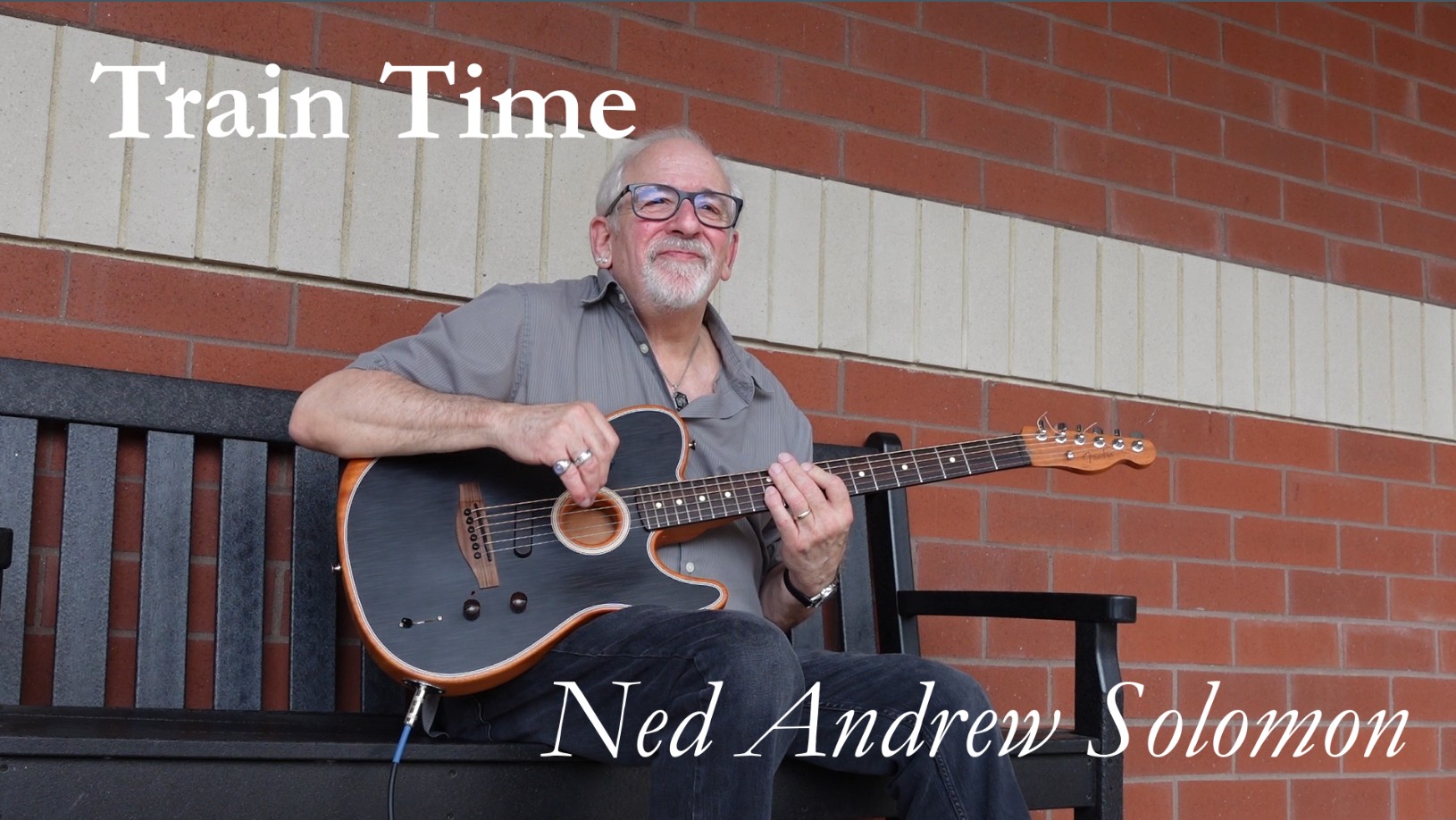 Train Time Thumbnail with Ned Andrew holding his Telecaster acoustic-electric Guitar